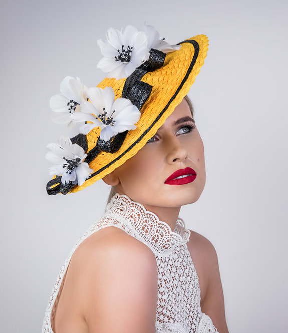 canary yellow boater hat with gorgeous white flowers and black ribbon trim